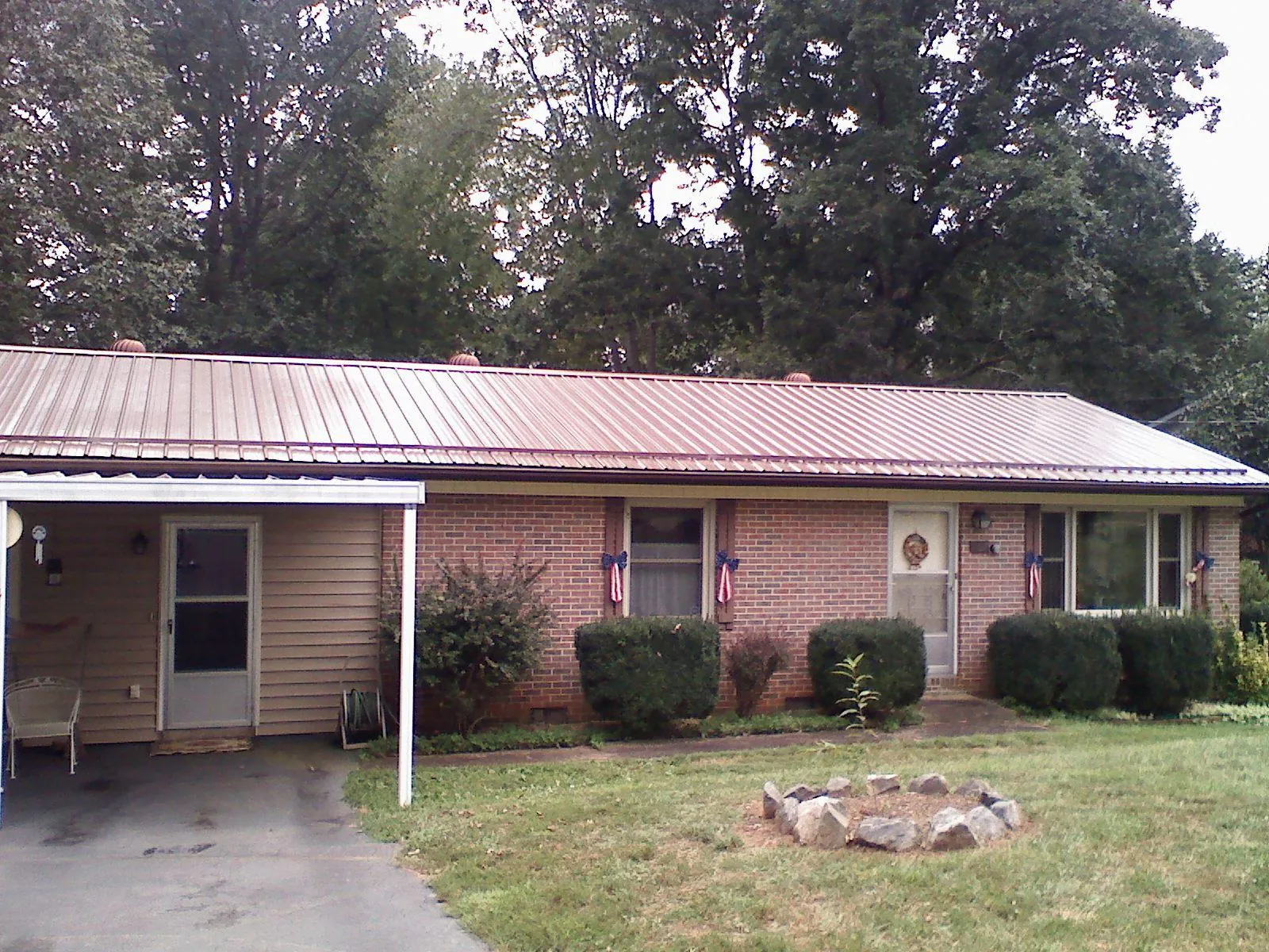 Bronze metal roof and carport on a brick ranch home — Roof Repair work by our crew in Toughkenamon